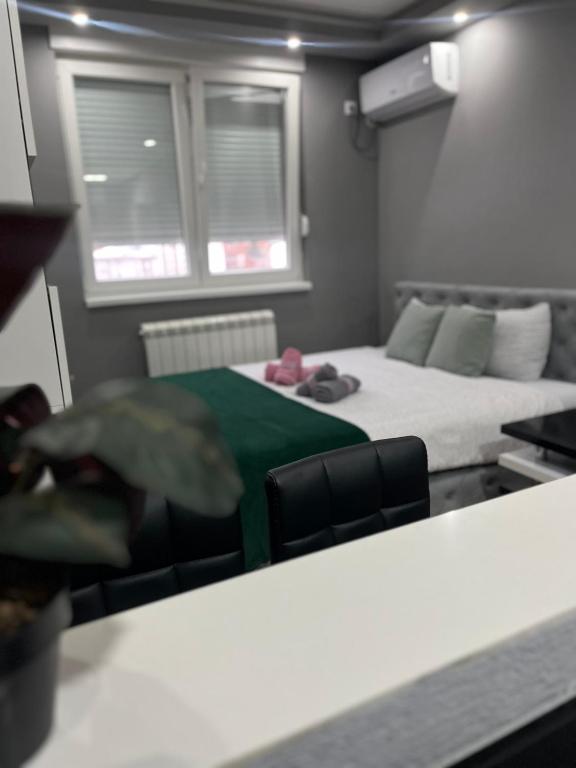 a small room with a bed and a couch at Apartman Hram Zvornik in Zvornik