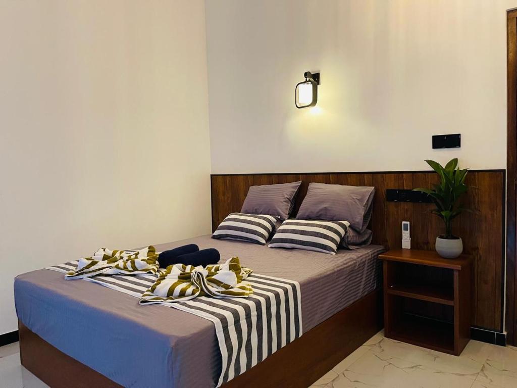 a bedroom with a bed with shoes on it at The Wasa Heaven in Hiriketiya