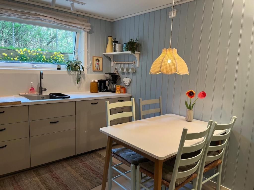 a kitchen with a table and chairs and a sink at Cozy place near Pulpit Rock in Strand
