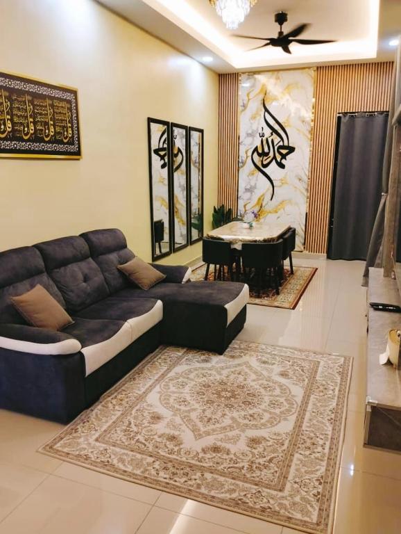 a living room with a couch and a table at Putera homestay in Juasseh