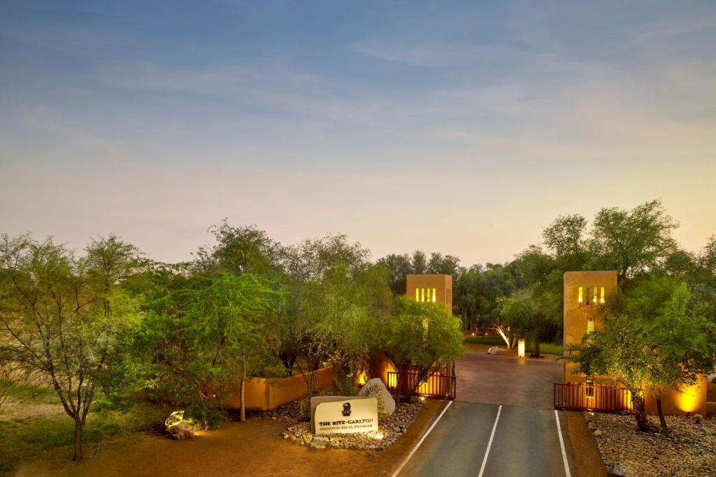 a house on a street with trees and a road at The Ritz-Carlton Ras Al Khaimah, Al Wadi Desert in Ras al Khaimah