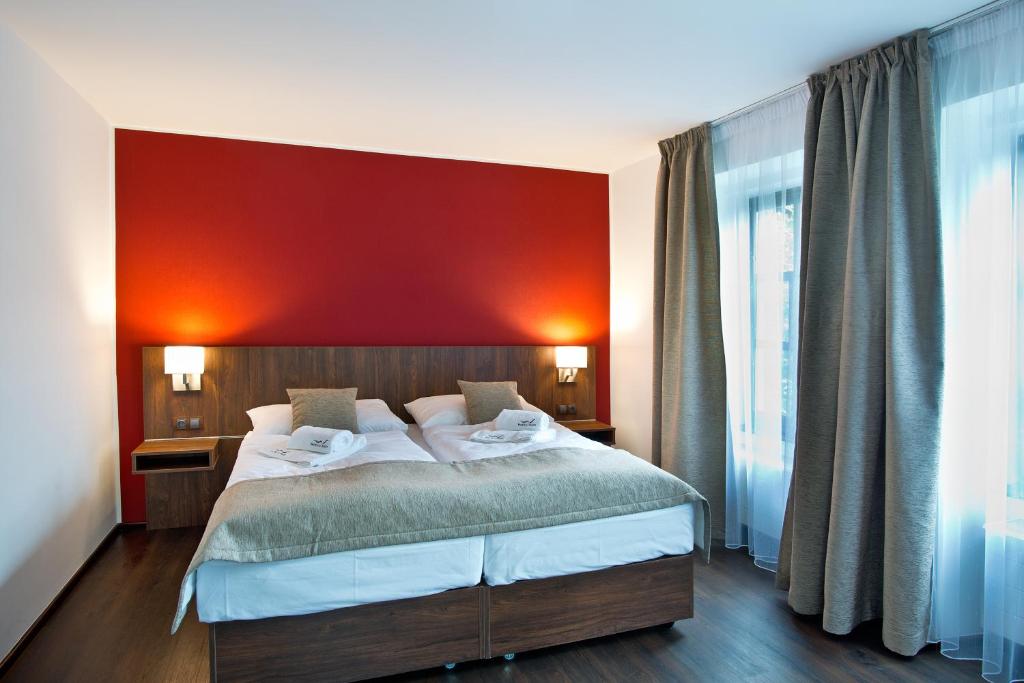 Postel nebo postele na pokoji v ubytování Hotel U Hada Žatec