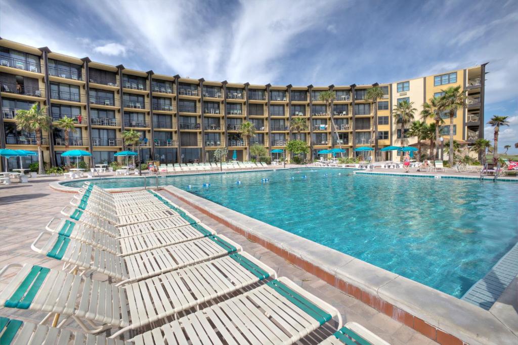 a large swimming pool in front of a hotel at Daytona Beach Hawaiian Inn in Daytona Beach