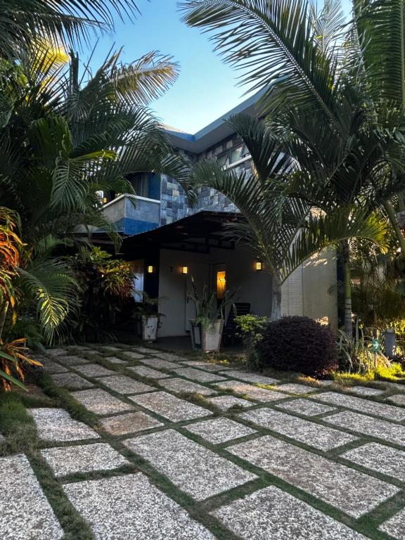a courtyard with palm trees in front of a building at Preety Blue Residence villas in Grand Baie