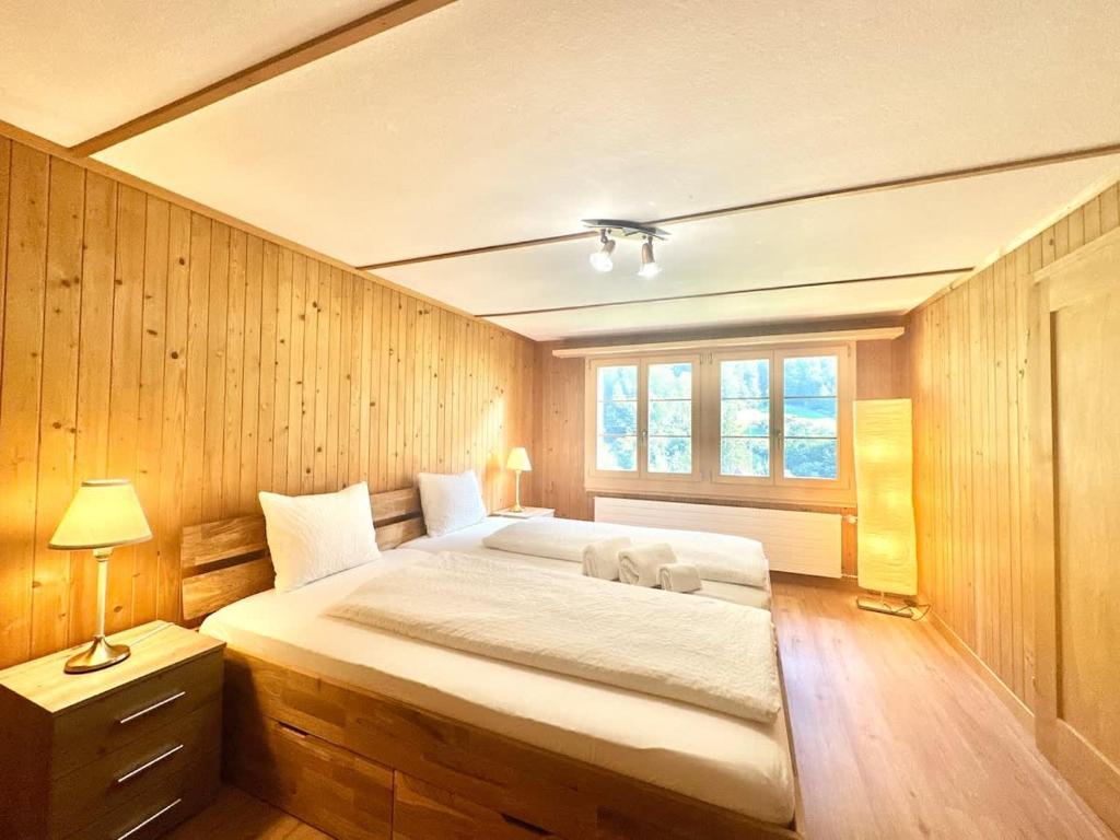 Ένα ή περισσότερα κρεβάτια σε δωμάτιο στο Scenic Stay Grindelwald Interlaken & Lauterbrunen