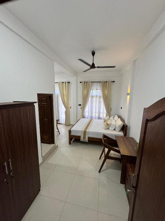a bedroom with a bed and a window at Avira Cozy Corner in Kilinochchi