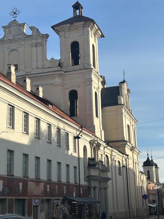 a building with a clock tower on top of it at Bookinn B&B Vilnius' Old Town in Vilnius