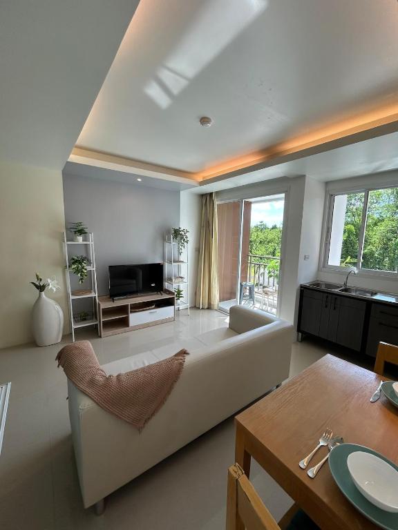 a living room with a couch and a table at Ao Nang Pool Condo in Ao Nang Beach