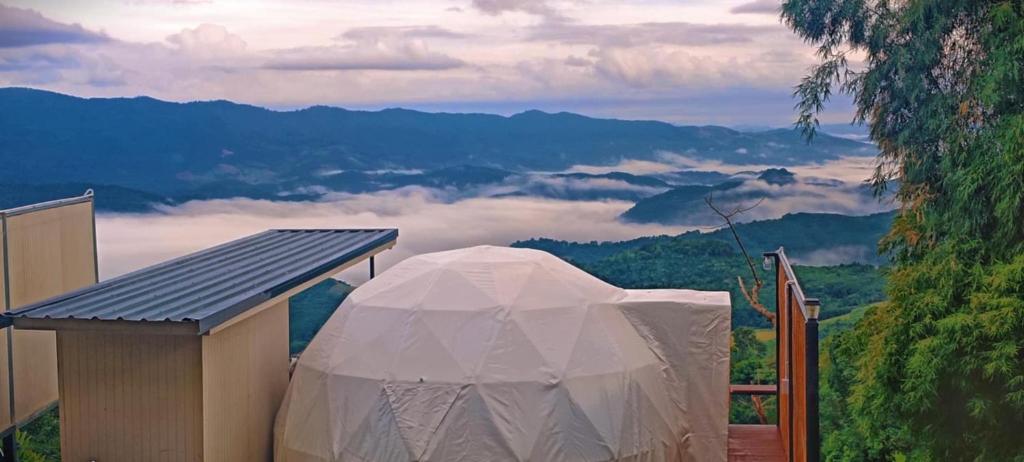 a large white tent sitting on top of a mountain at โฮมสเตย์ภูชี้ฟ้า in Ban Huai Khu