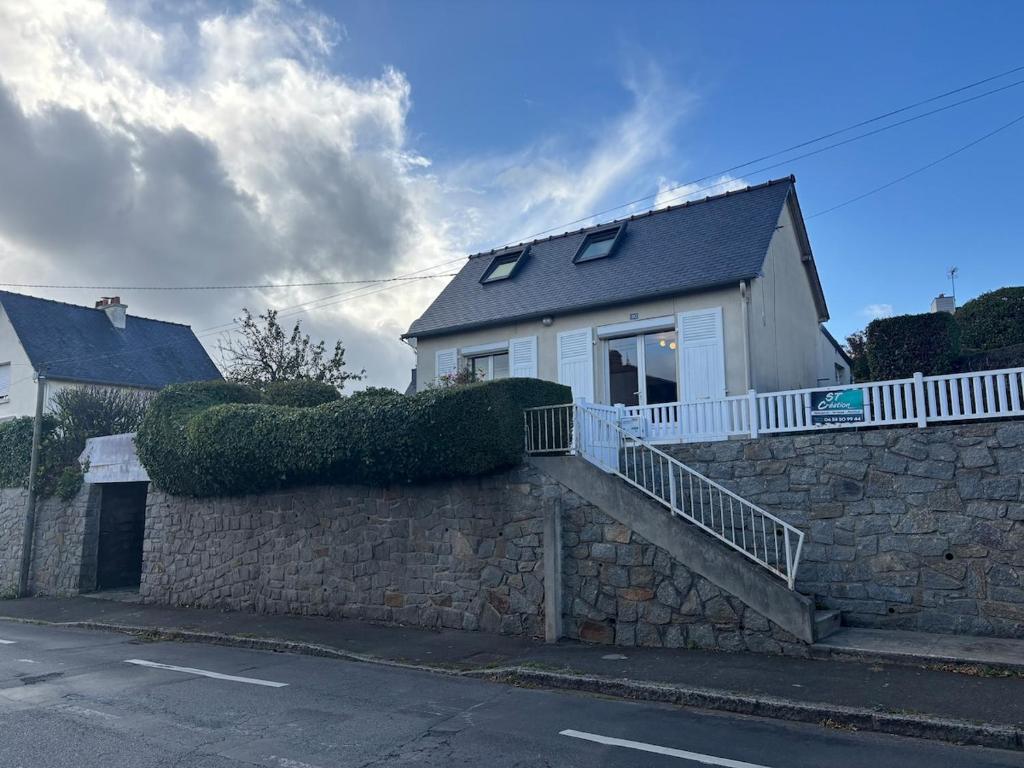 a house on top of a stone wall at A 800 metres de la plage, maison de vacances, parking, terrasse in Plérin