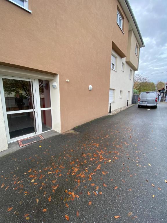 a car parked in a parking lot next to a building at Bartappart in Bartenheim