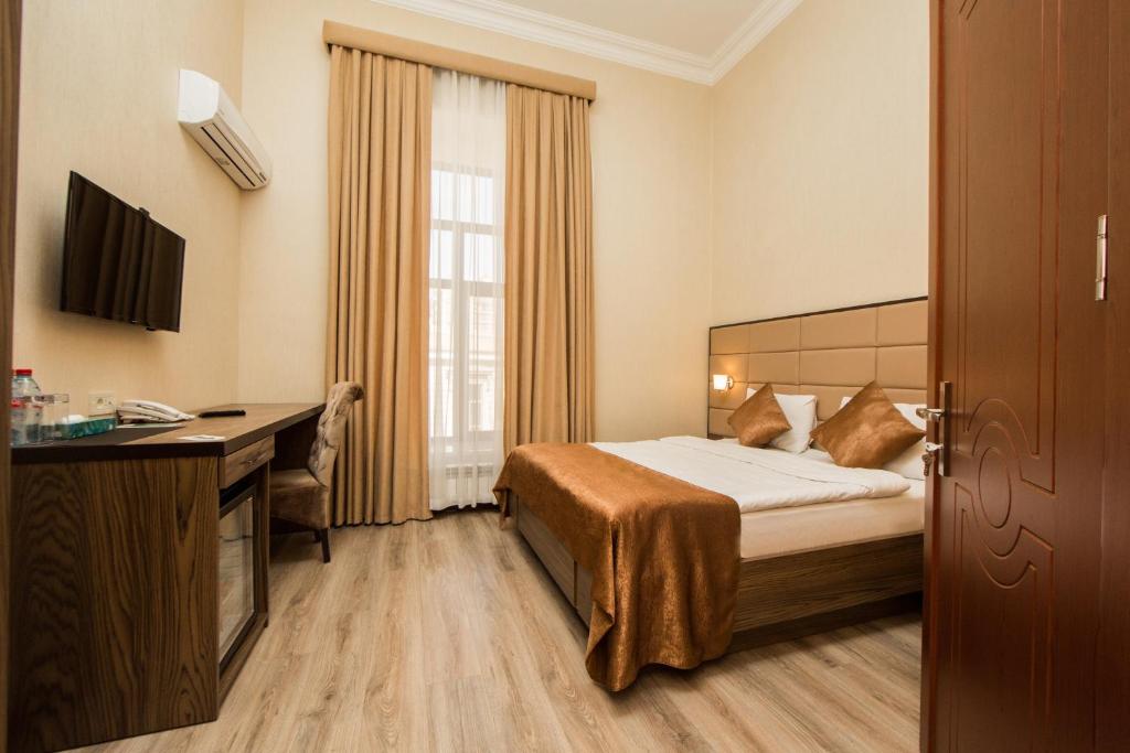 Ένα ή περισσότερα κρεβάτια σε δωμάτιο στο Old Passage Hotel