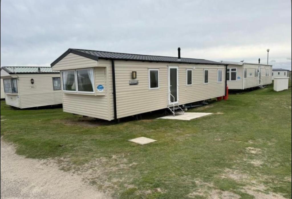 a row of mobile homes parked in a field at Haven Holiday Park Perran Sands in Perranporth