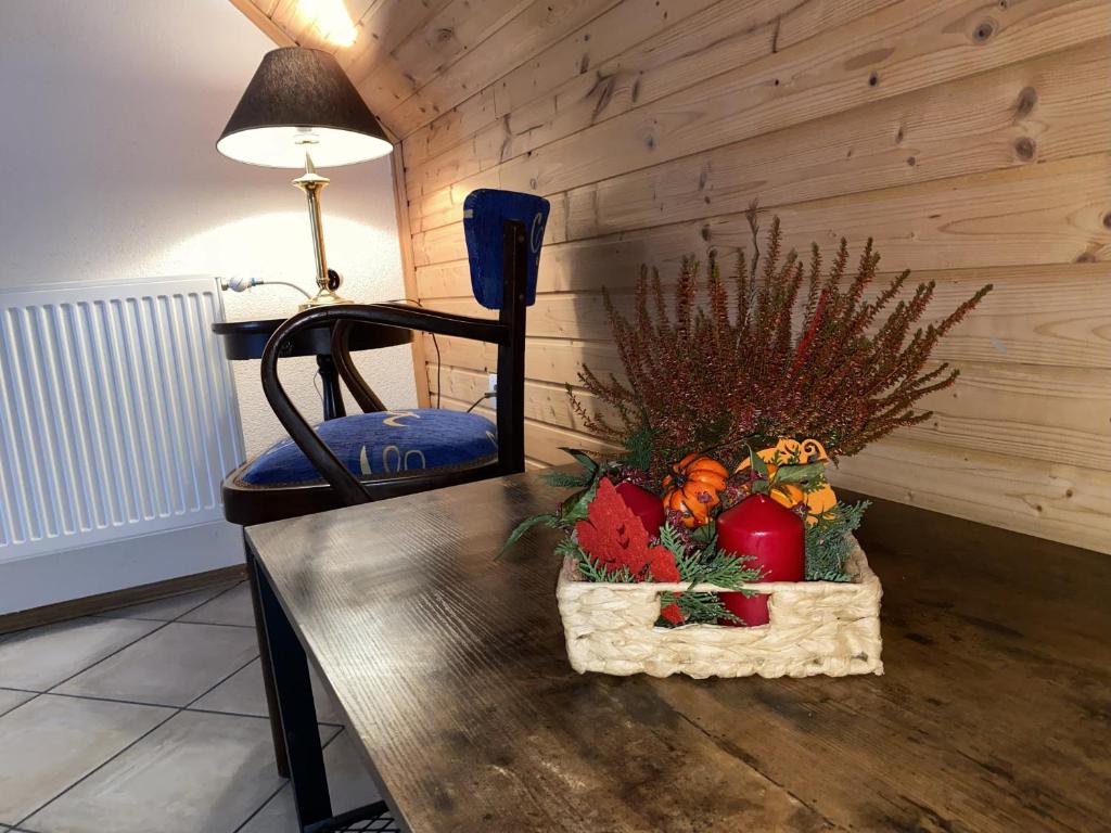 a table with a basket of fruits and vegetables on it at Pension Harmony in Bešeňová