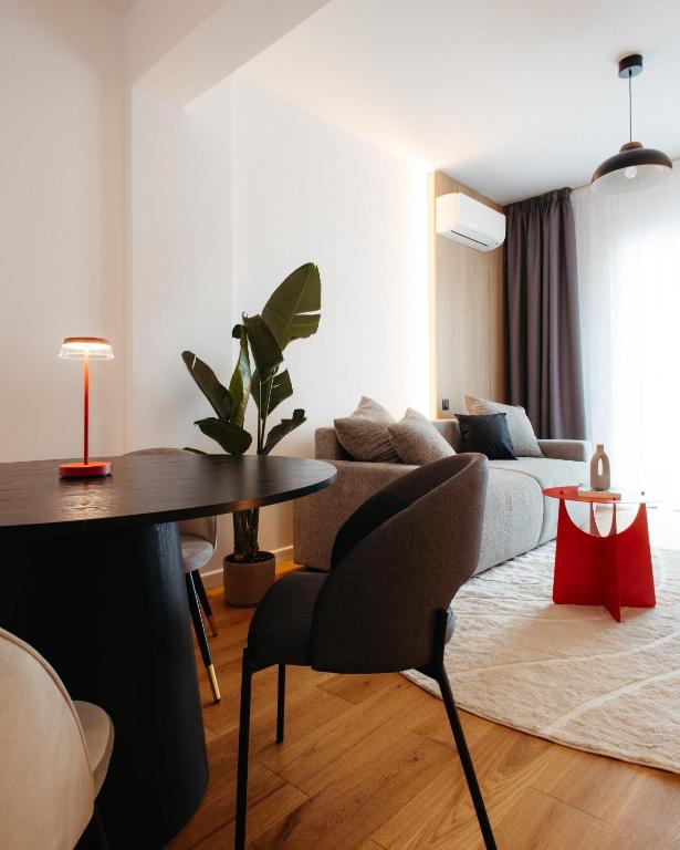 a living room with a couch and a table at Campus - Palas Moonlight in Iaşi
