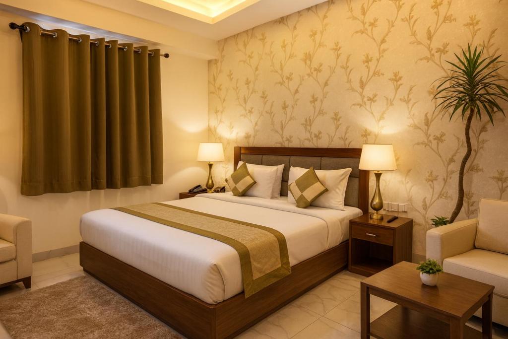 a hotel room with a bed and a chair at Hotel Krishna Palace, Vrindavan - Lavish & Luxury rooms with parking near prem mandir #By Om # in Vrindāvan