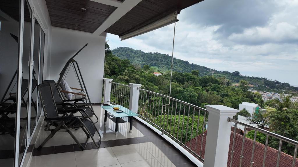 a balcony with a table and chairs and a view at Modern apartment in Patong Center in Ban Nong Chaeng