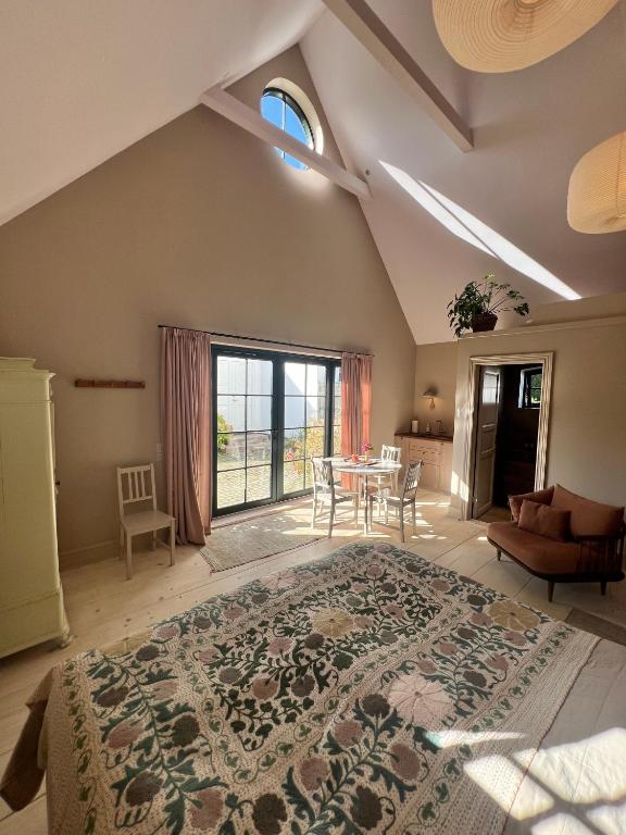 a bedroom with a large bed and a table at Luxury Guesthouse, 30 min from Copenhagen in Stenløse