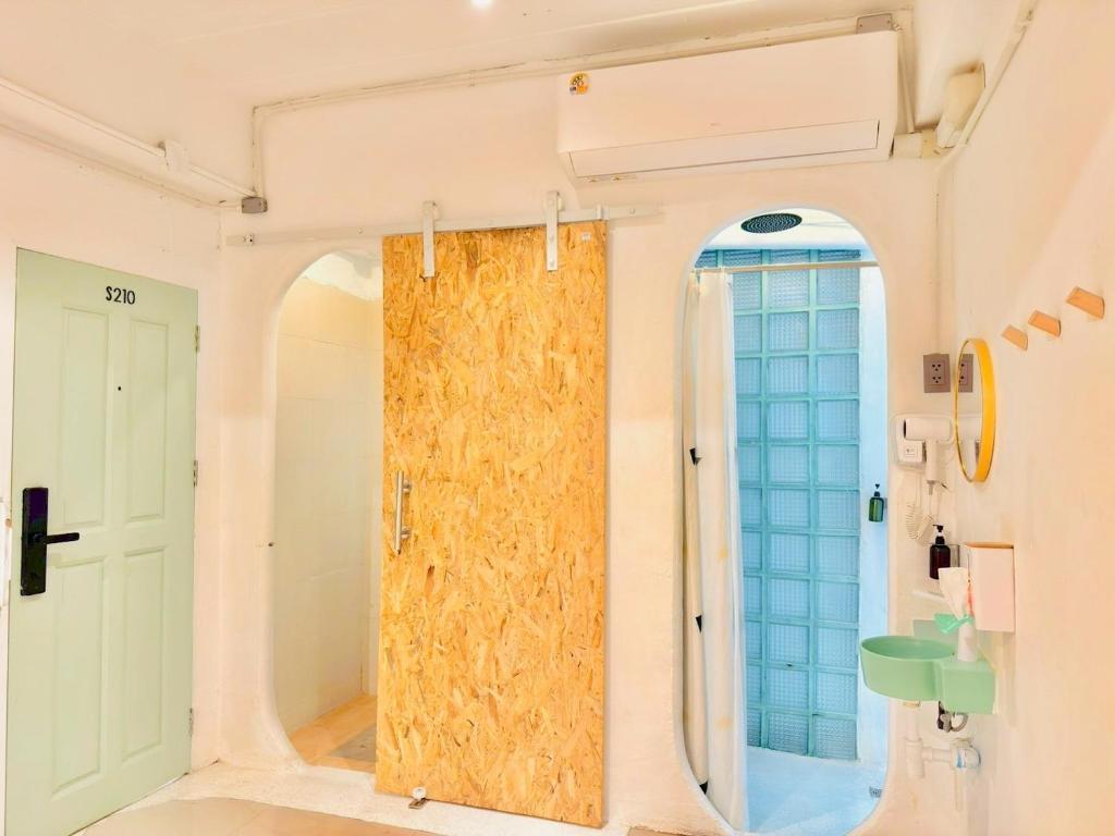 a bathroom with a large window and a mirror at Lazy Sunday Khaosan Hotel in Bangkok