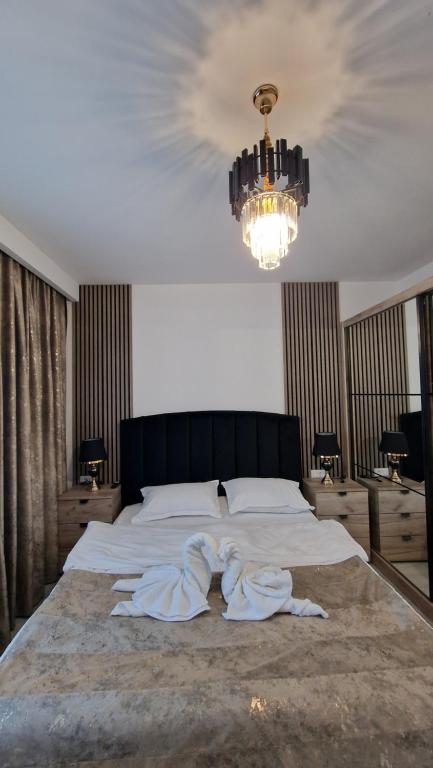 a bedroom with a large bed with towels on it at Apartament EVA in Suceava