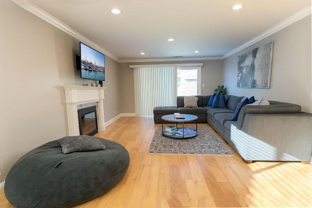 a living room with a couch and a table at @ Marbella Lane Seaside Retreat, Walk to the Beach in Half Moon Bay