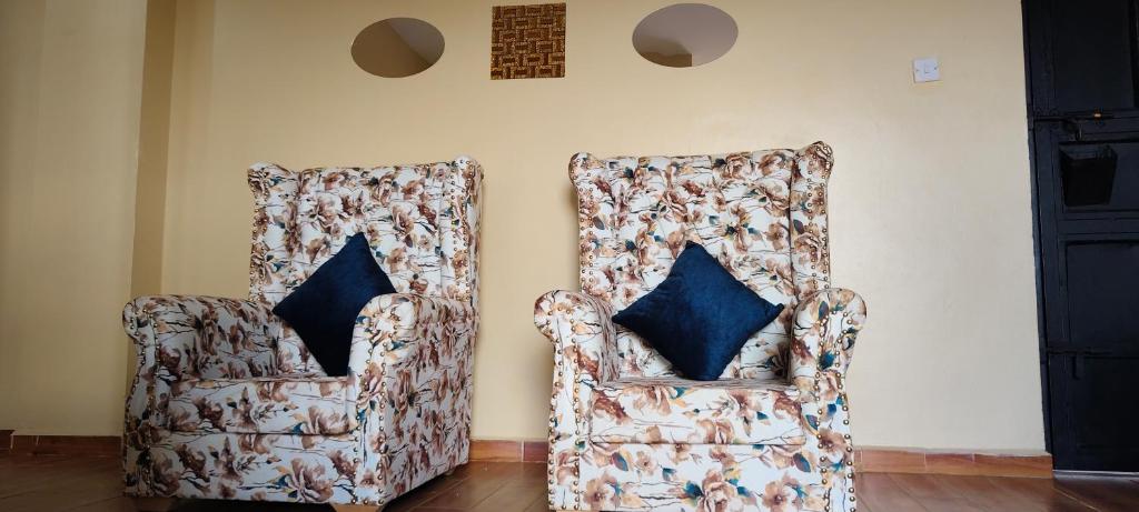 two chairs sitting next to each other in a room at Nyota Haven Stays in Libwezi