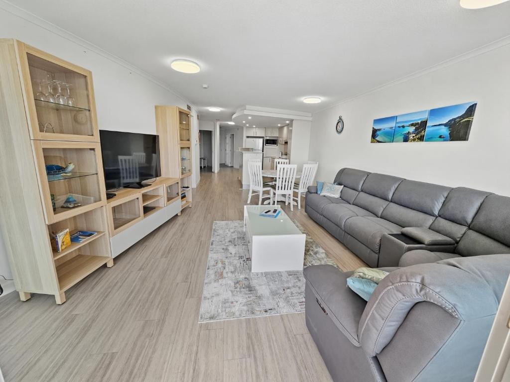 a living room with a couch and a table at Seaside Sovereign Retreat in Caloundra