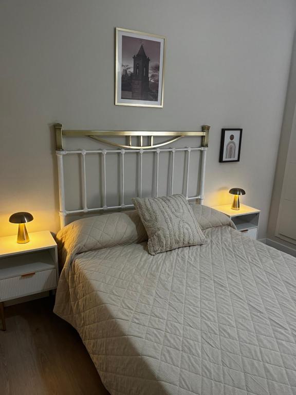 a bedroom with a large bed with two night stands at La terraza de la subbética in Luque