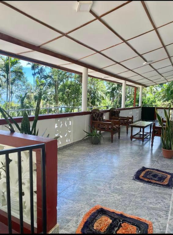 a large room with a patio with tables and chairs at Heart Whispering in Kandy