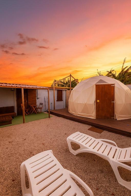 a yurt with a chair and a mattress on a patio at ADAMA Glamping in Chiclana de la Frontera