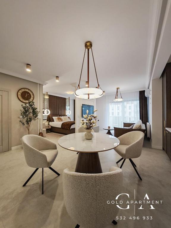 a living room with a table and chairs at Gold Apartment E47 Studio Let's Sea Baltic Park Gąski in Gąski
