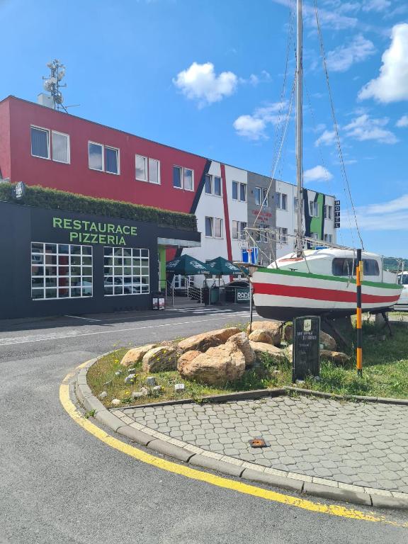 a boat sitting on the ground in front of a building at Hotel Montenegro in Bruntál
