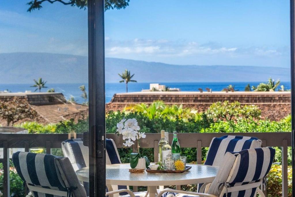 a table and chairs with a view of the ocean at Kaanapali Plantation 18 · KPL 18: Ocean views, beach nearby, com in Lahaina