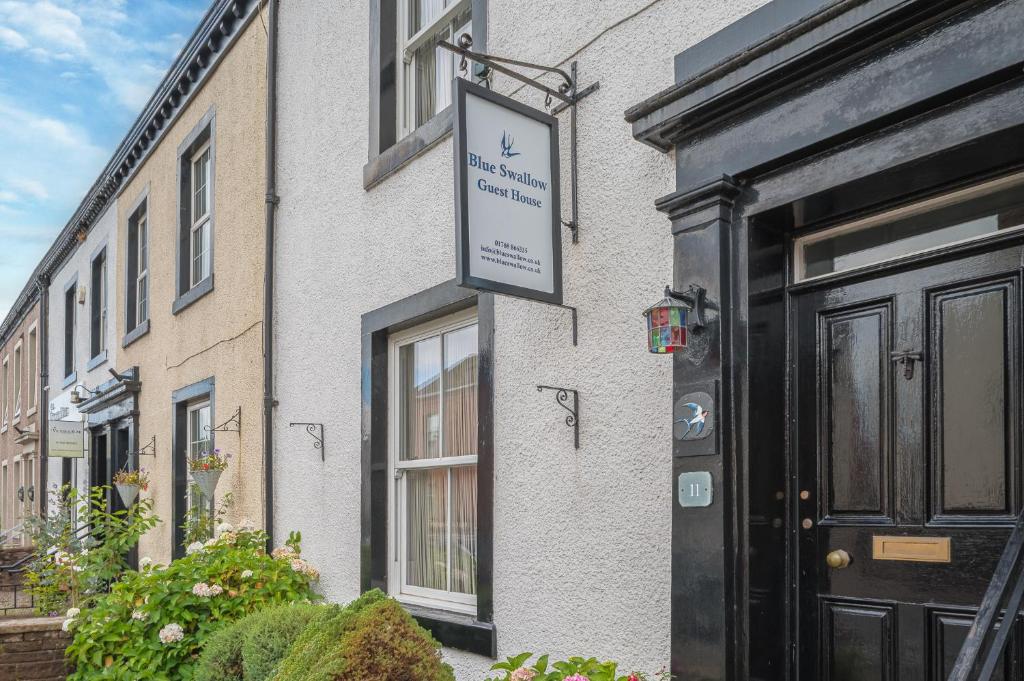 a sign on the side of a building at Blue Swallow in Penrith