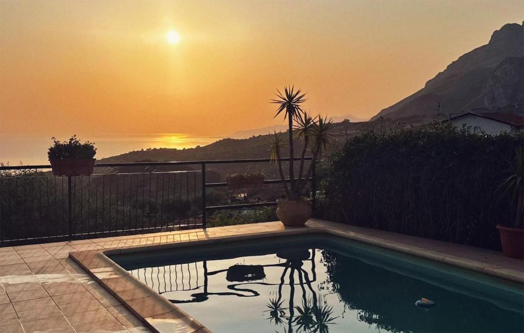 a swimming pool with a sunset in the background at Gorgeous Home In Caccamo With Private Swimming Pool, Can Be Inside Or Outside in Caccamo