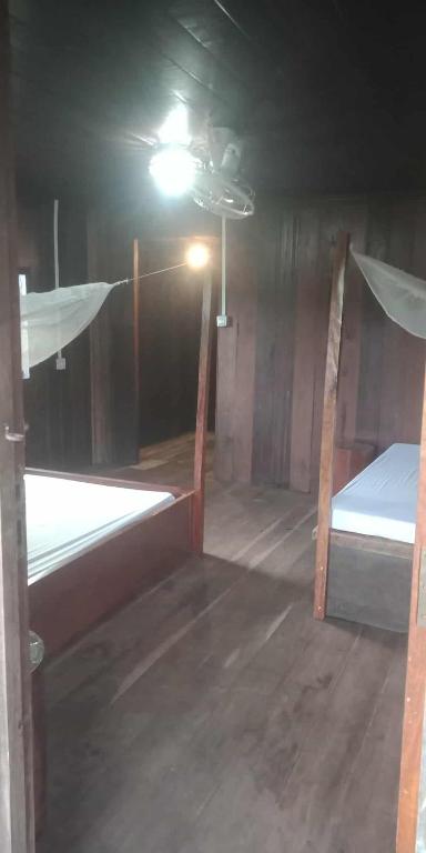a room with two bunk beds and a light at Avocados homestay in Banlung