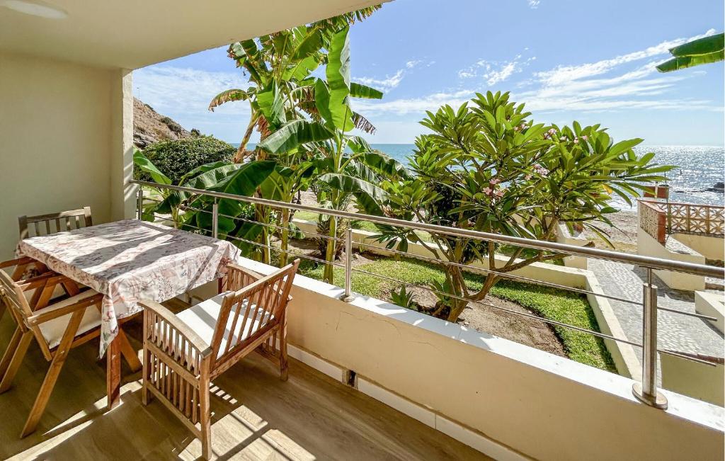 a balcony with a table and chairs and the ocean at 1 Bedroom Lovely Apartment In Benalmadena in Torremuelle