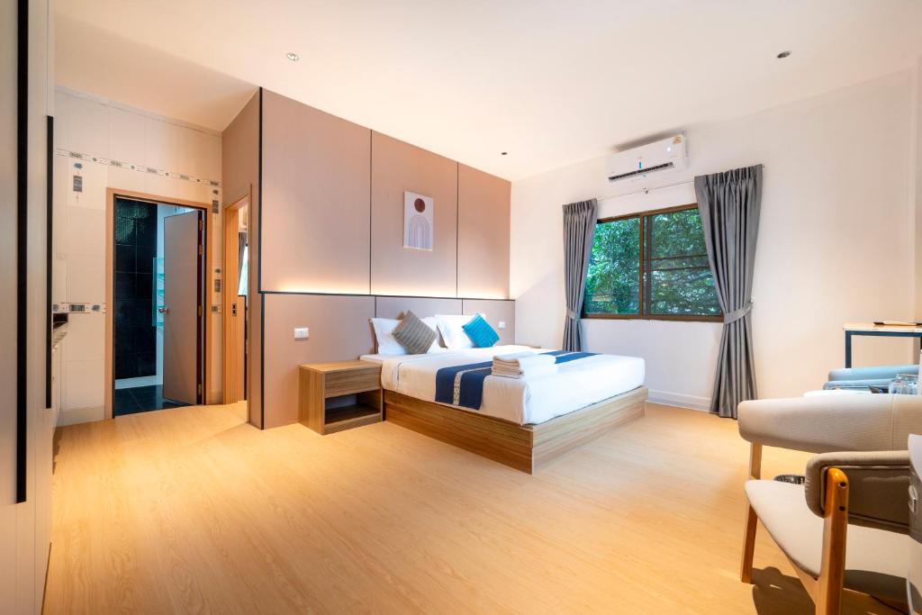 a hotel room with a bed and a window at Selina Place Hotel in Pattaya South