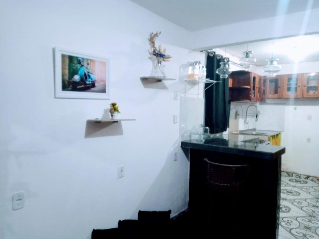 a kitchen with white walls and a black counter at Perto da vila cop30 in Belém
