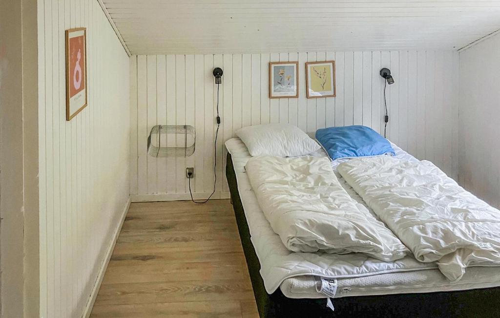 a bed in a small room with two pillows at Nice Home In Sydals With Wifi in Høruphav
