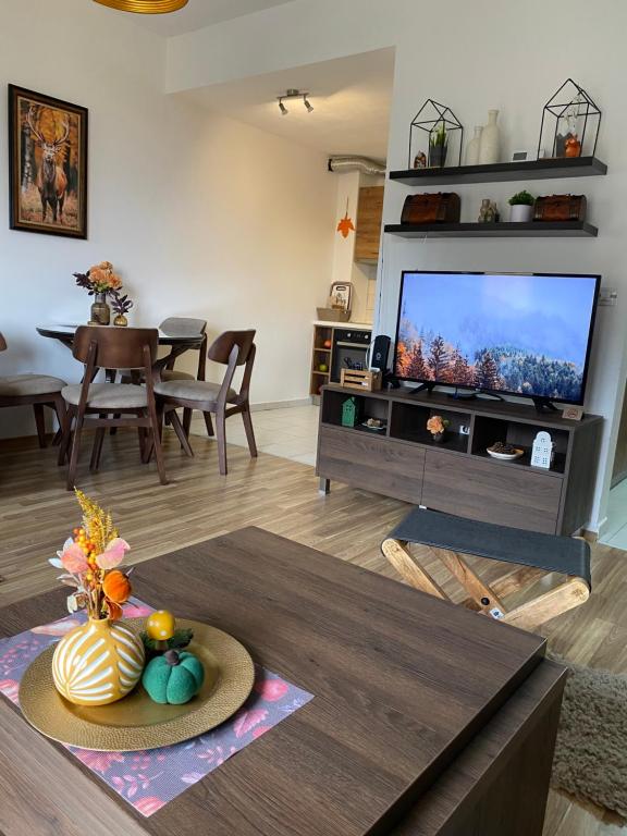 a living room with a television and a table at Moun2 in Mavrovo
