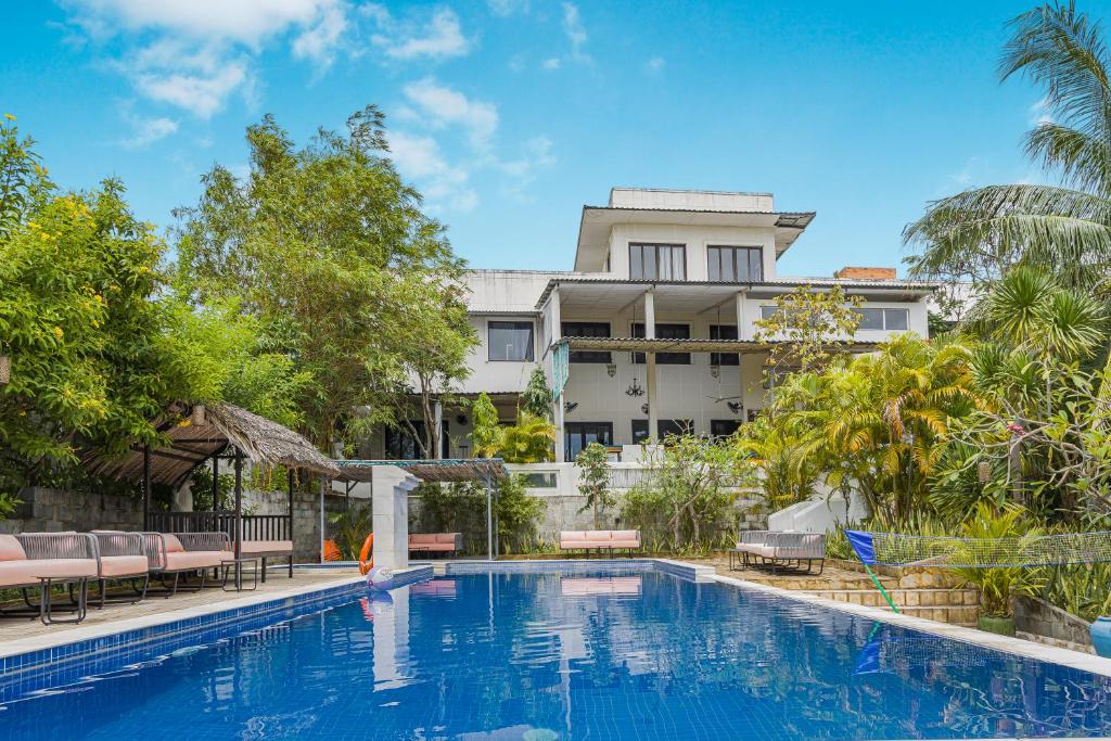 a swimming pool in front of a building at 9 Bedroom Villa Mui Ne With Private Pool in Mui Ne