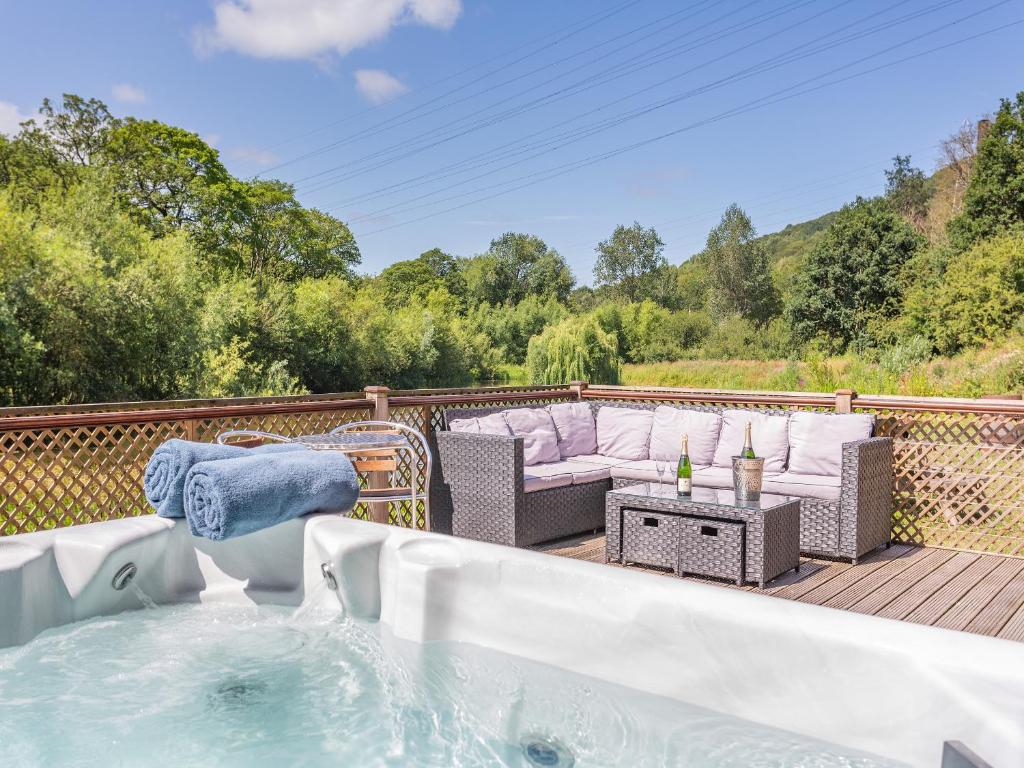 a hot tub on the deck of a house at Waterside Lodge Sixteen - Uk13038 in Southowram