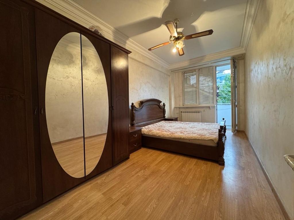 a bedroom with a bed and a large mirror at Apartment in Republic Square in Yerevan