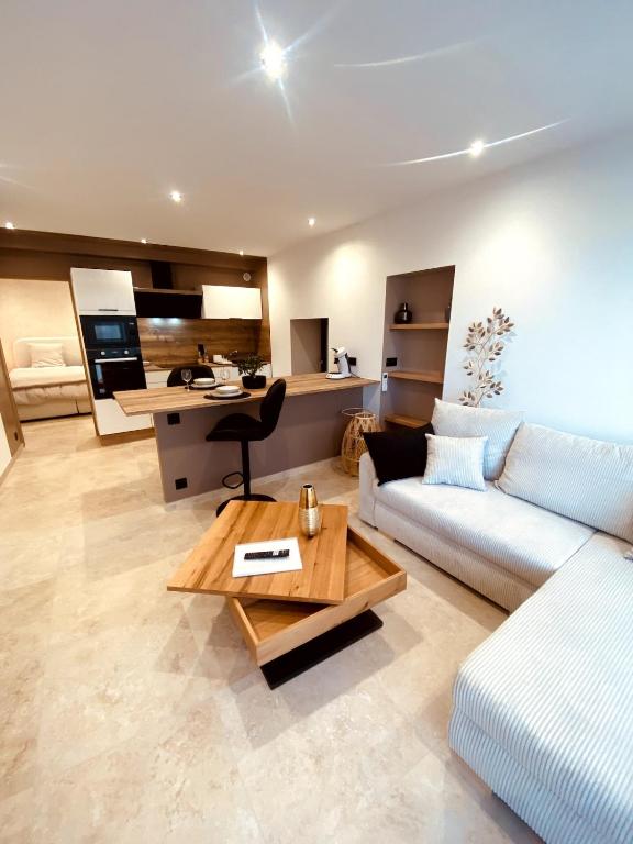 a living room with a couch and a table at Appartement Fiorentina in Saint-Avold
