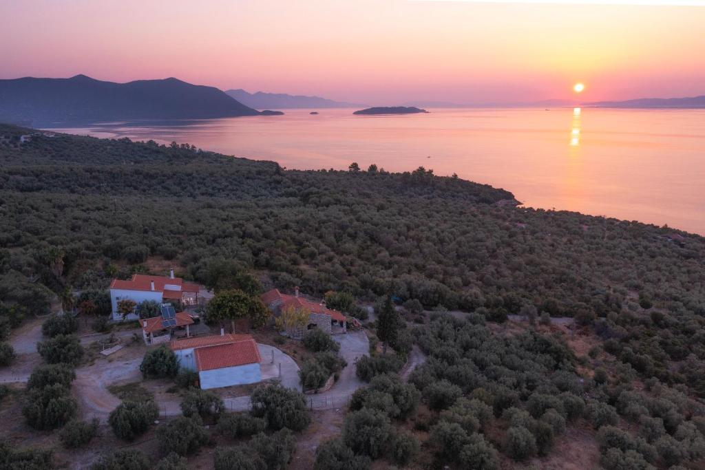 an aerial view of a house and the ocean at sunset at SIX INDEPENDENT HOUSES BY THE sea in Glífa