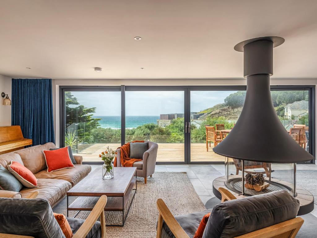 a living room with a view of the ocean at Blue Seas in Mawgan Porth
