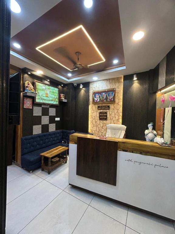 a store with a counter and a bench in a room at Hotel Priyanshi Palace in Ujjain