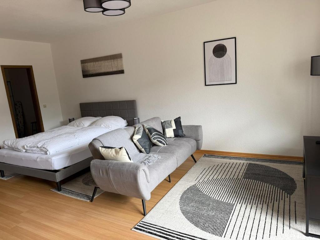 a living room with a couch and a bed at FEWO mit Balkon in Osnabrück
