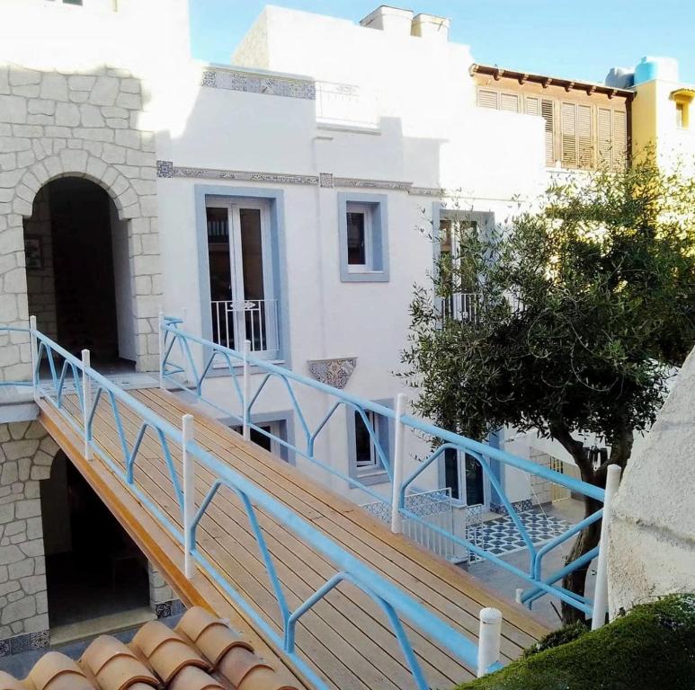 a wooden ramp leading up to a white building at Al Baglio di Sant'Elia in Santa Flavia